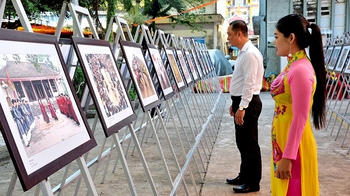 Visitors admiring photos on display at the exhibition.