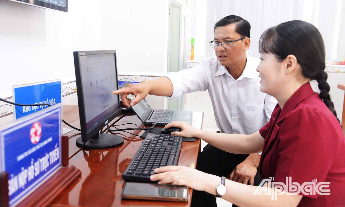 Công chức Trung tâm Phục vụ hành chính công xã Tân Phước 1 hướng dẫn người dân thực hiện nộp hồ sơ trực tuyến.