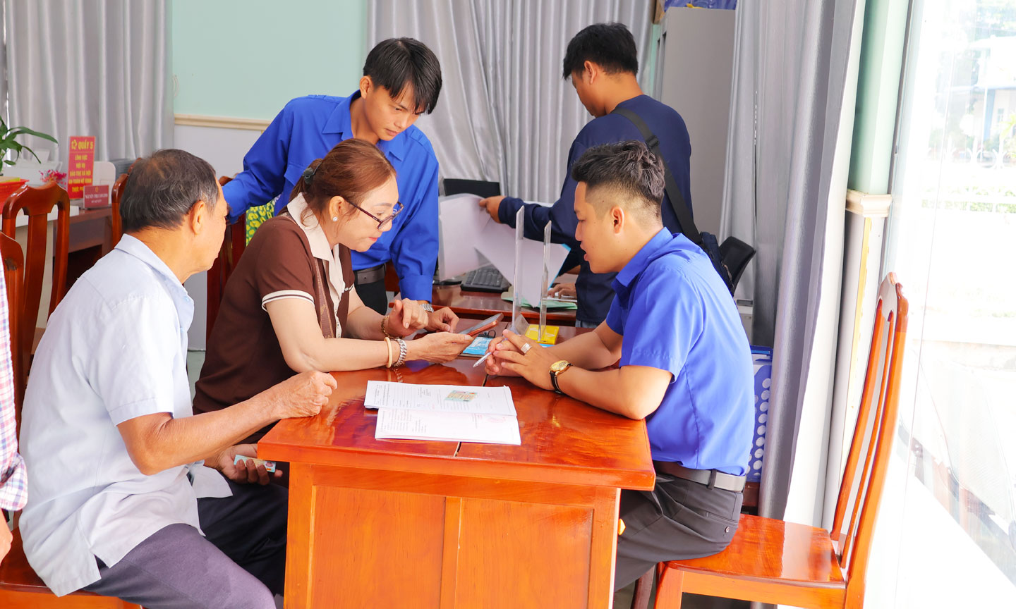 Đoàn viên, thanh niên hướng dẫn người dân làm thủ tục hành chính qua điện thoại thông minh.