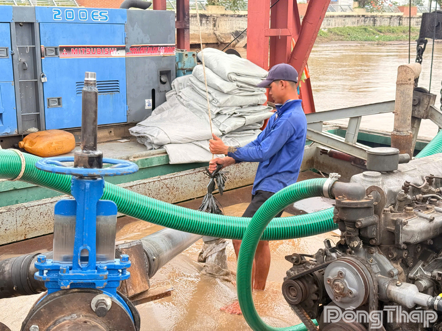 Đơn vị thi công tiến hành bơm và thả bao cát để lấp các hố bị sụp lún kè Thường Thới Tiền.